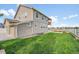 Spacious backyard with a well-maintained lawn, garden area, and attractive fencing at 5478 Teton Dr, Longmont, CO 80504