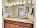 Well-lit bathroom with double sink vanity, granite countertop, and large mirrors at 5478 Teton Dr, Longmont, CO 80504