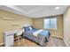 Bedroom featuring a comfortable bed, a well-lit desk area, and a window at 5478 Teton Dr, Longmont, CO 80504