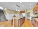 Open kitchen featuring a large island with seating, stainless steel appliances, and a pantry at 5478 Teton Dr, Longmont, CO 80504