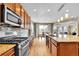 Kitchen with stainless steel appliances, granite counters, and hardwood floors at 5478 Teton Dr, Longmont, CO 80504