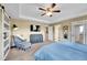 Comfortable main bedroom featuring a tray ceiling, ceiling fan, and en-suite bathroom at 5478 Teton Dr, Longmont, CO 80504