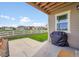Covered patio with grill, overlooking a well-manicured lawn and neighborhood at 5478 Teton Dr, Longmont, CO 80504