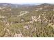 Beautiful mountain neighborhood with winding roads, surrounded by lush trees and breathtaking views at 6574 Olympus Dr, Evergreen, CO 80439