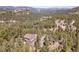 Picturesque mountain estate featuring lush greenery, scenic views, and a charming driveway at 6574 Olympus Dr, Evergreen, CO 80439