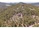 Serene mountain setting featuring luxurious homes surrounded by lush forest and scenic landscapes at 6574 Olympus Dr, Evergreen, CO 80439