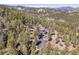 Secluded mountain home nestled amongst tall pine trees with a private driveway and breathtaking mountain views at 6574 Olympus Dr, Evergreen, CO 80439