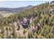 Stunning mountain home nestled among lush trees, offering seclusion and breathtaking views at 6574 Olympus Dr, Evergreen, CO 80439
