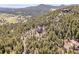 Idyllic mountain property showcasing lush trees, scenic vistas, and a winding driveway at 6574 Olympus Dr, Evergreen, CO 80439