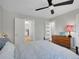 Comfortable bedroom with a wrought iron bed frame, dresser, and views into the hall at 6574 Olympus Dr, Evergreen, CO 80439