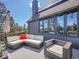 Outdoor patio with wicker seating, an umbrella, and gorgeous views of the surrounding mountain landscape at 6574 Olympus Dr, Evergreen, CO 80439