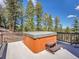 Relaxing hot tub on the back deck with gorgeous mountain views and mature landscaping for privacy and enjoyment at 6574 Olympus Dr, Evergreen, CO 80439