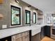 Bright kitchen featuring farmhouse sink, stainless steel appliances, and hexagon tile backsplash at 6574 Olympus Dr, Evergreen, CO 80439