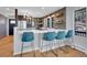 Modern kitchen featuring an island with seating and stainless steel appliances, and hexagon backsplash at 6574 Olympus Dr, Evergreen, CO 80439