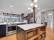 Kitchen with stainless steel appliances, white countertops, and island with a microwave at 6574 Olympus Dr, Evergreen, CO 80439