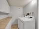 Well-lit laundry room with ample counter space and modern appliances for convenience at 6574 Olympus Dr, Evergreen, CO 80439