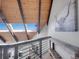 Loft with wood ceiling, skylights, cow art, metal railings, and access to library; bright, open architectural detail at 6574 Olympus Dr, Evergreen, CO 80439