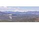 Scenic view of rolling mountain peaks and lush green valleys with snow-capped peaks in the distance on a clear day at 6574 Olympus Dr, Evergreen, CO 80439