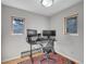 Functional office space with two large monitors, comfortable chair, natural light from windows, and a colorful area rug at 6574 Olympus Dr, Evergreen, CO 80439