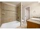 Bathroom featuring tiled tub/shower, tile floor and vanity with granite counters at 865 S Quebec St # 103B, Denver, CO 80247