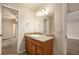 Bathroom featuring a vanity with granite counters, tile floor and large mirror at 865 S Quebec St # 103B, Denver, CO 80247