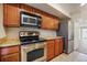 Kitchen featuring stainless steel appliances, wood cabinets and granite countertops at 865 S Quebec St # 103B, Denver, CO 80247