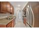 Kitchen with stainless steel appliances, granite counters and wood cabinets at 865 S Quebec St # 103B, Denver, CO 80247