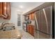 Kitchen with stainless steel appliances, granite counters and wood cabinets at 865 S Quebec St # 103B, Denver, CO 80247