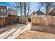 Private backyard with a wood fence, a concrete walkway, and access to the back of the property at 3135 California St, Denver, CO 80205