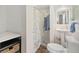 Bathroom with a pedestal sink, shower with curtain, and convenient shelving at 3135 California St, Denver, CO 80205
