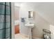 Loft bathroom featuring a pedestal sink, shower, and lots of natural light at 3135 California St, Denver, CO 80205