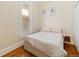 Cozy bedroom with hardwood floors, natural light, and neutral decor at 3135 California St, Denver, CO 80205