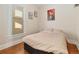 Bedroom featuring hardwood floors, a window, and simple decor at 3135 California St, Denver, CO 80205