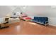 Large bedroom with multiple beds, futon, and hardwood floors at 3135 California St, Denver, CO 80205