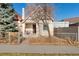 A cozy single-Gathering home with a quaint front porch, classic architectural features, and a small fenced yard at 3135 California St, Denver, CO 80205