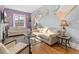 Well-lit living room features neutral furniture, hardwood floors, and cozy atmosphere at 3135 California St, Denver, CO 80205
