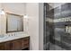 Modern bathroom features a stone shower, vanity with storage, and white marble countertops at 242 Point View Pl, Breckenridge, CO 80424