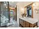 Hallway bathroom featuring double doors, wood cabinets and trim, walk-in shower, and natural light at 242 Point View Pl, Breckenridge, CO 80424