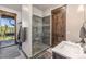 Modern bathroom boasts a stylish tiled shower with glass door, a sink, and a door providing access to a chair lift at 242 Point View Pl, Breckenridge, CO 80424