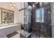 Contemporary bathroom with a glass shower, soaking tub, and stone accents at 242 Point View Pl, Breckenridge, CO 80424