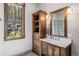 Bathroom featuring wood cabinetry, a marble countertop, and a shower view of surrounding trees at 242 Point View Pl, Breckenridge, CO 80424