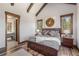 Comfortable bedroom featuring natural light, wood flooring and trim, and an ensuite bathroom at 242 Point View Pl, Breckenridge, CO 80424