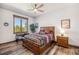 Cozy bedroom featuring rustic wood accents, a ceiling fan, and a lovely mountain view from the window at 242 Point View Pl, Breckenridge, CO 80424