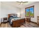 Charming bedroom with hardwood floors, a ceiling fan, and a window with natural scenery at 242 Point View Pl, Breckenridge, CO 80424