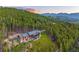 Scenic home exterior nestled hillside surrounded by lush forest, mountain views, and a tranquil atmosphere at 242 Point View Pl, Breckenridge, CO 80424