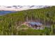 Stunning home nestled on hillside surrounded by lush forest, showcasing mountain views and a peaceful retreat at 242 Point View Pl, Breckenridge, CO 80424