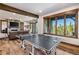 Game room with a ping pong table and floor-to-ceiling windows showing stunning scenery at 242 Point View Pl, Breckenridge, CO 80424