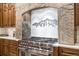 Gourmet kitchen with professional-grade stainless steel range, stone accents, and custom wood cabinetry at 242 Point View Pl, Breckenridge, CO 80424