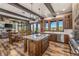 Spacious open concept kitchen with granite island, wood beams, mountain views, and stainless steel appliances at 242 Point View Pl, Breckenridge, CO 80424