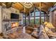 Living room with a stone fireplace, vaulted wood ceilings, and large windows with a mountain view at 242 Point View Pl, Breckenridge, CO 80424